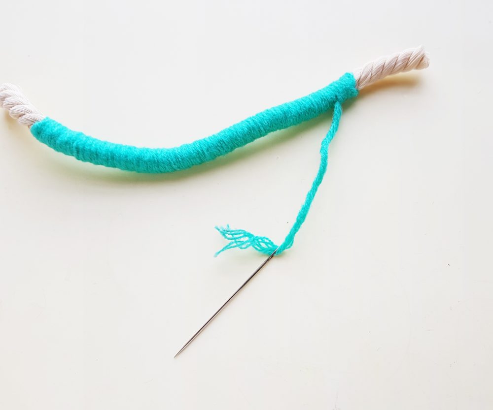 draw tapestry needle through yarn for step 5