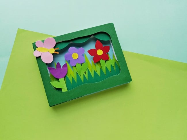 3D garden paper craft - completed craft. A 3D garden with a butterfly and three flowers.
