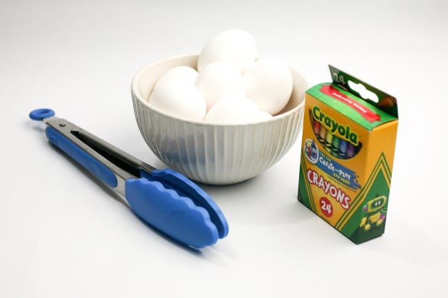 Easter egg craft - items needed for craft: eggs in a bowl, salad tongs, and box of crayons