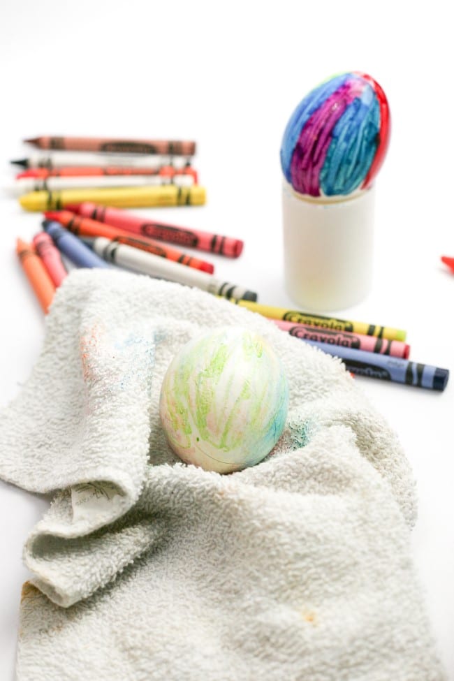 Melted Crayon Easter egg craft - finished colorful Easter eggs with crayons around them