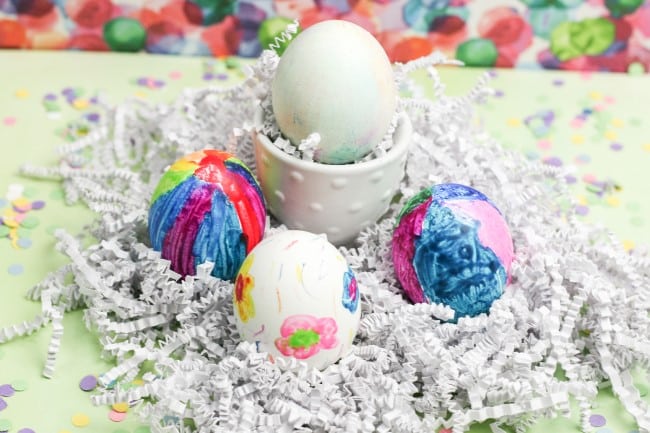 Easter egg craft - four colored eggs, one in holder, three nested in shredded paper