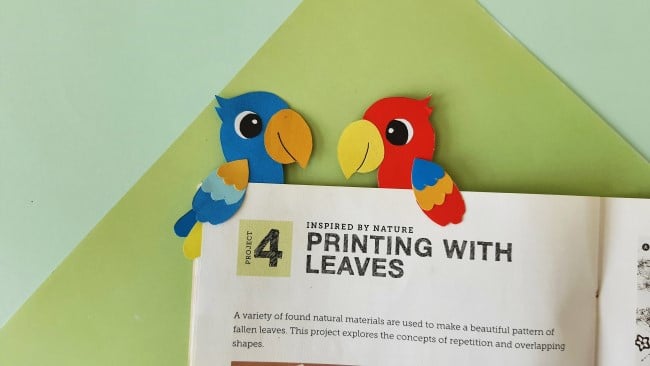parrot paper bookmark - two parrot bookmarks facing each other on a book
