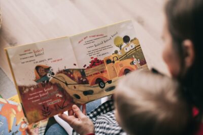 mother reading with toddler child