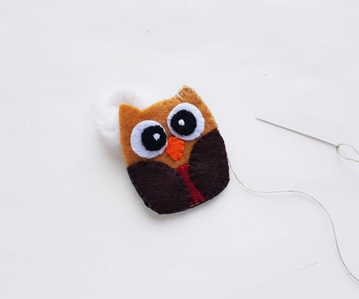 stuffing the owl plush with cotton