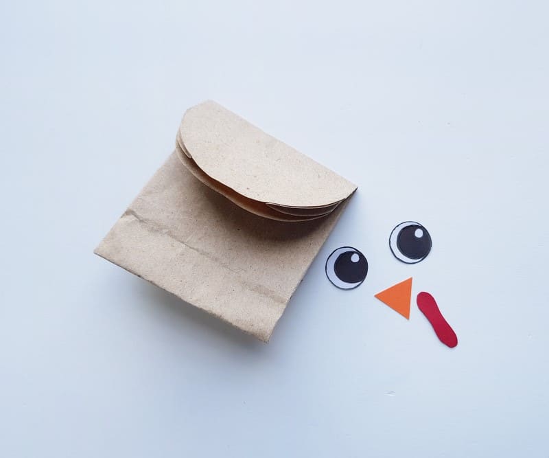 paper bag turkey - step two with cut out eyes, beak, and wattle